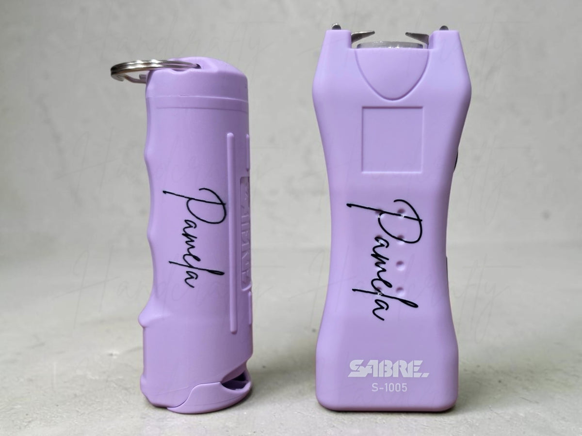 Close up of custom name UV printed on purple safety self defense keychain tool
