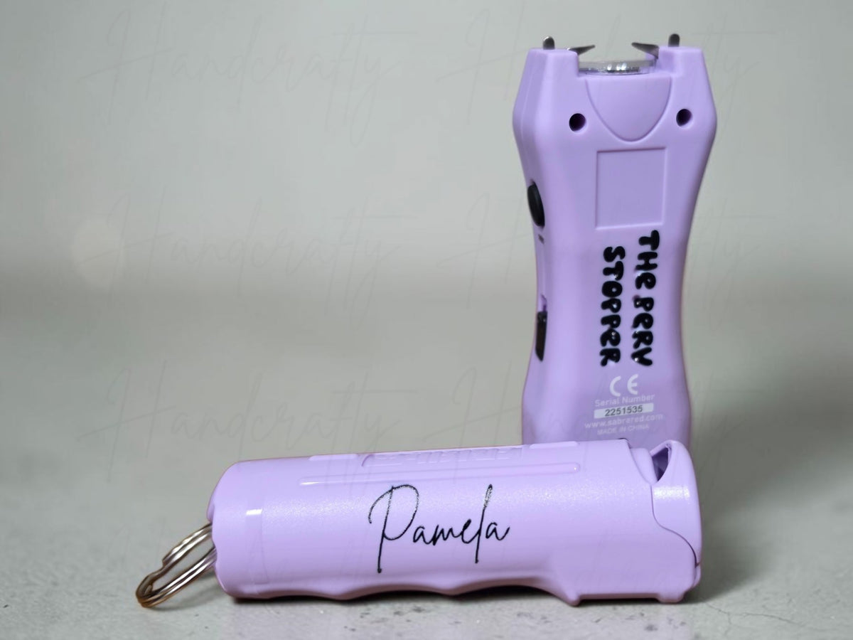 Woman holding a custom engraved safety keychain set and pepper spray combo